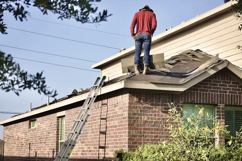 Professional roofer working on a residential roof in Northwest Village